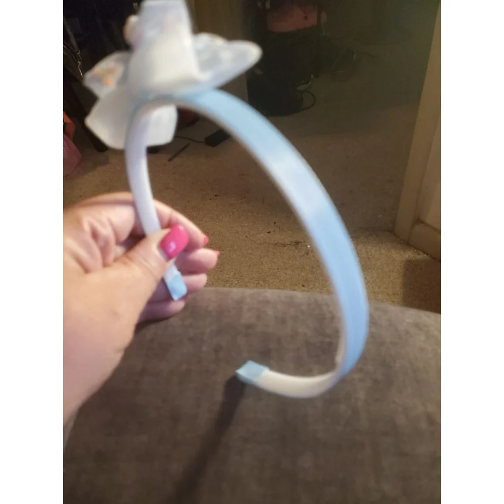 Four Hello Kitty headbands with small figurine
